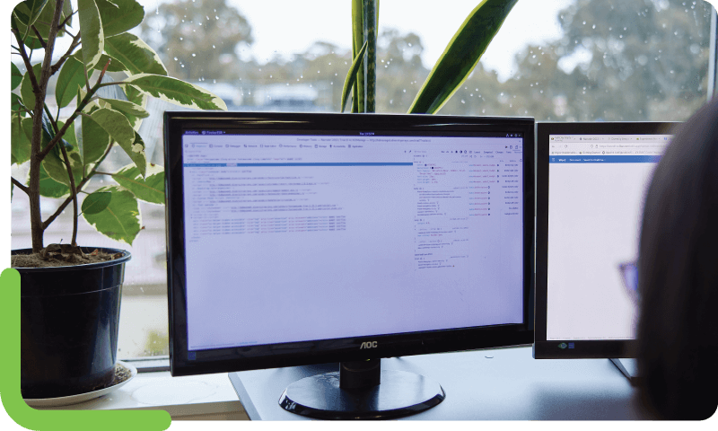 A software developer sitting in front of a computer to program bioinformatics software