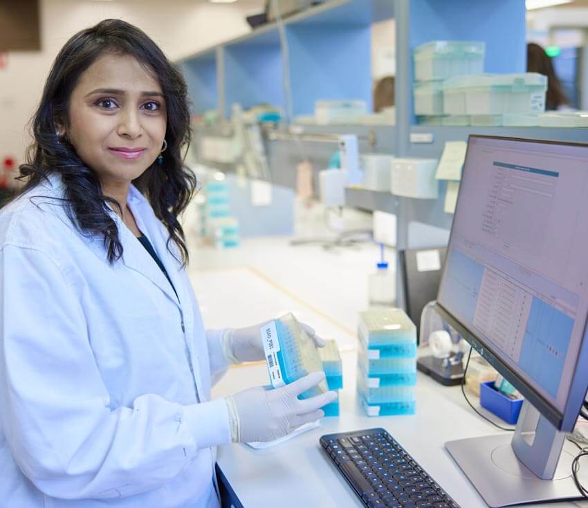 Expert genetic scientist handling micro well plates for genomic analysis of plants and seeds