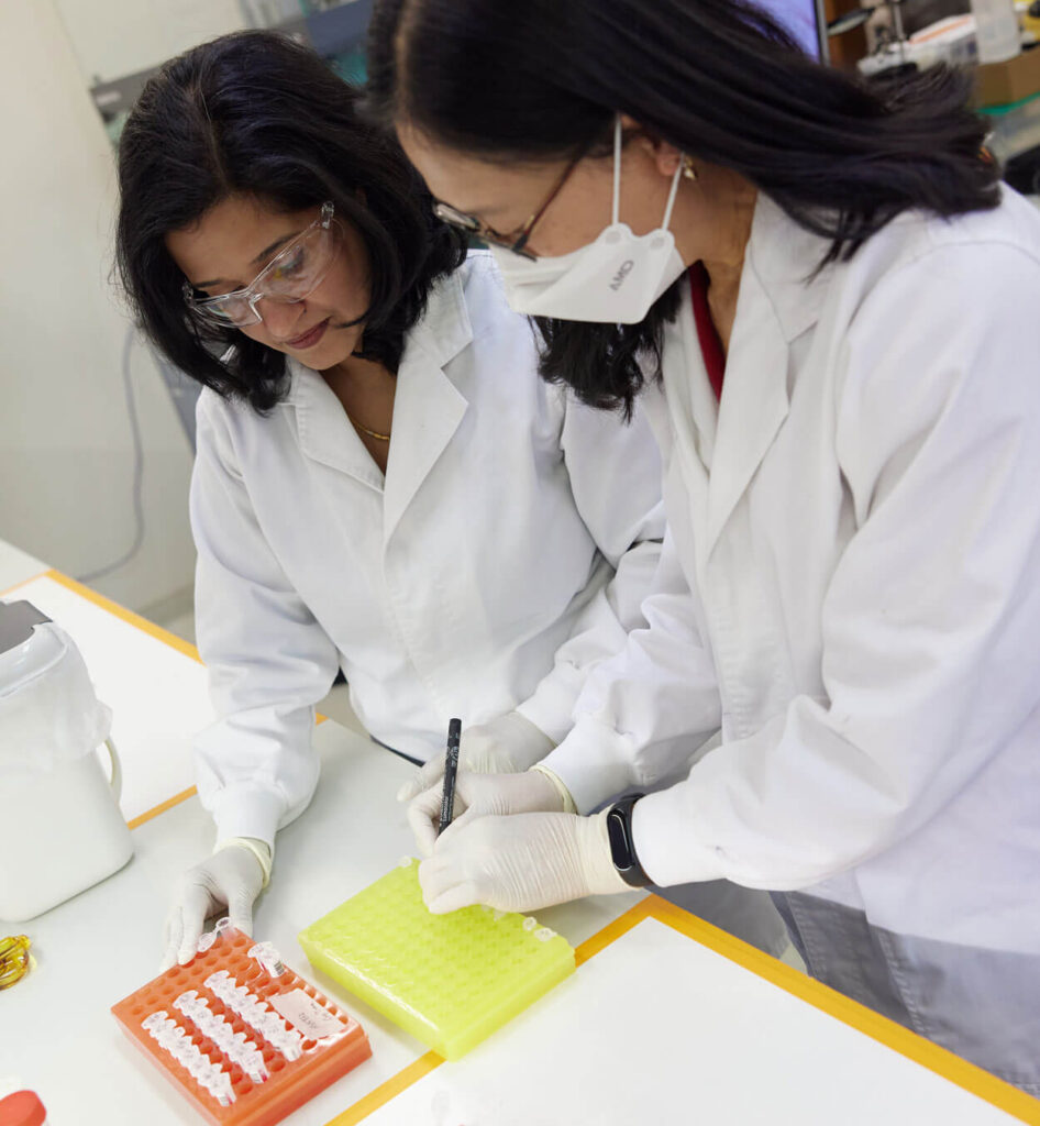 Two genetic laboratory scientists studying genomic analysis of plants and seeds